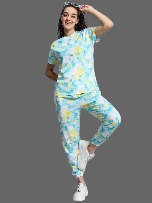 Woman wearing a colorful tie-dye outfit on a gray background